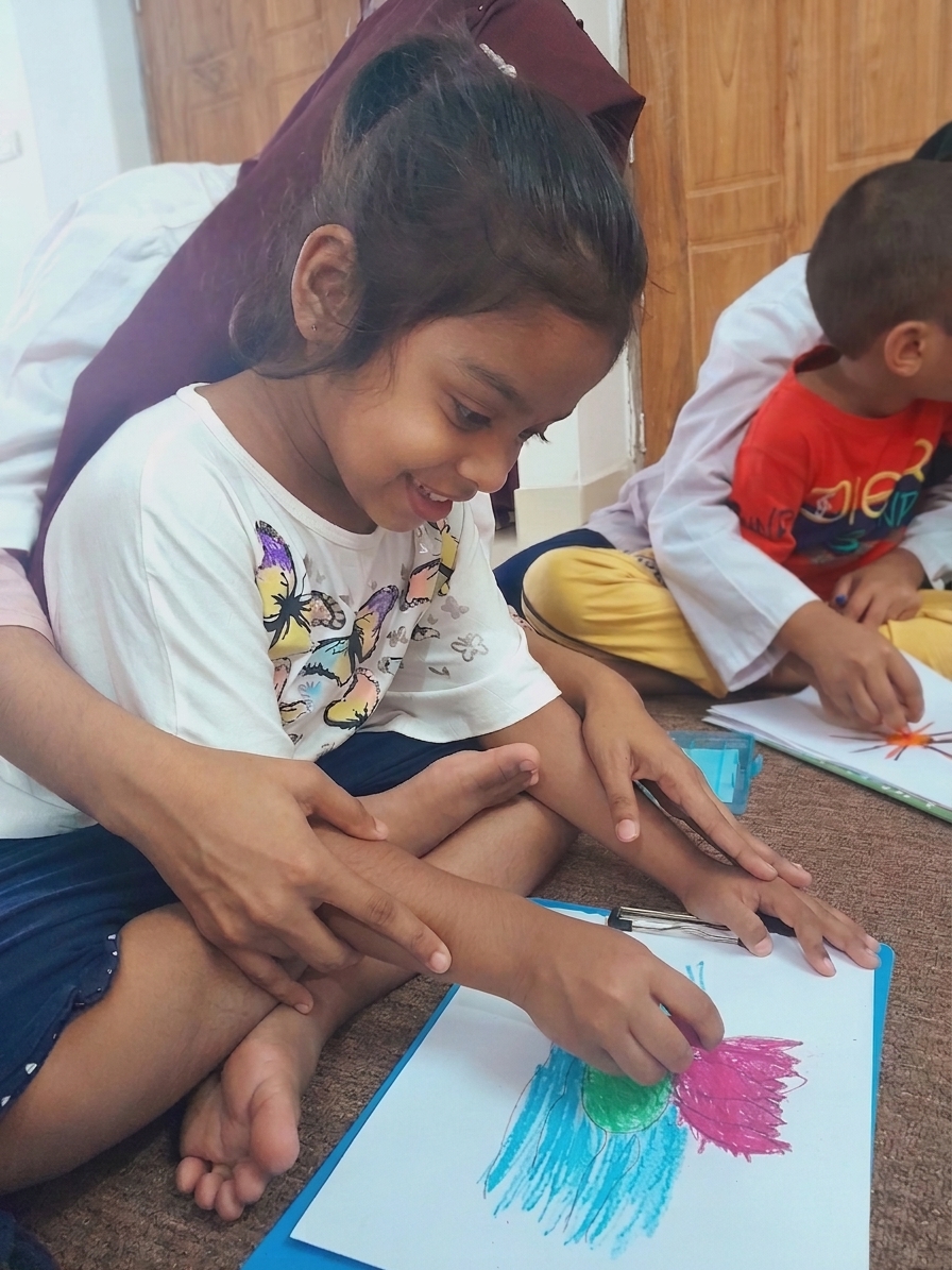 A child drawing during a session at Angel Foundation